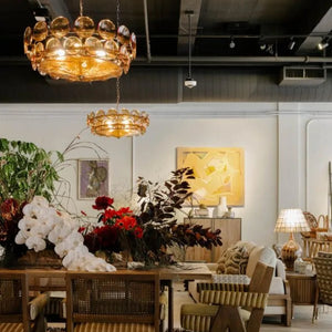 A stylish living and dining area with wooden furniture, floral table arrangements, and abstract wall art in a well-lit room, featuring the Italian Retro Pendant Light as an elegant centerpiece.