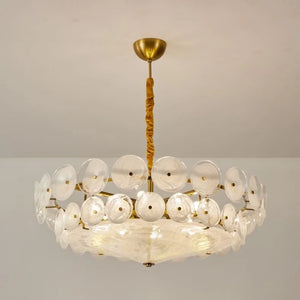 The Italian Retro Pendant Light features a round brass frame and two tiers of clear disc-shaped glass, bringing Mid-Century Modern elegance and Italian artisan style to your space as it hangs gracefully from the ceiling.
