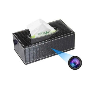 The SpyCam Tissue Box is pictured in black, featuring a discreet hidden camera lens, indicating its dual function as a tissue holder and a reliable surveillance device.