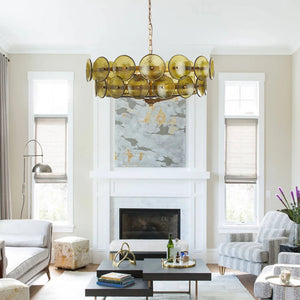 A modern living room features an Italian Retro Pendant Light, white fireplace, abstract wall art, patterned armchair, and neutral decor.