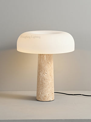 Introducing the Mushroom Desk Lamp—a sleek and modern lighting piece featuring a white glass dome shade and a cylindrical beige stone base. Placed on a light-colored surface against a gray wall, this lamp beautifully blends organic inspiration with contemporary design for sophisticated desk lighting.