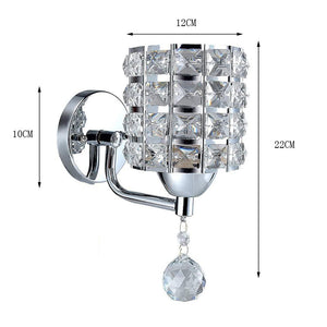 The Luxury Cylinder Wall Light features a crystal design with a decorative hanging crystal, measuring 22 cm high, 12 cm wide, and 10 cm deep for an elegant modern touch.