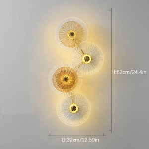 The Amber Deco Wall Sconce features a nature-inspired design with four vertically arranged round glass discs, emitting warm light. Dimensions: 62 cm high, 32 cm wide.