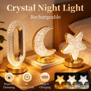 Three Crystal Table Lamps—shaped like an oval, a crescent moon, and a star—stand on gold bases atop the bedside table. Each elegant lamp offers dimming capabilities, a rechargeable battery, Type-C charging, and convenient touch controls, making them the perfect stylish addition to your bedside décor.
