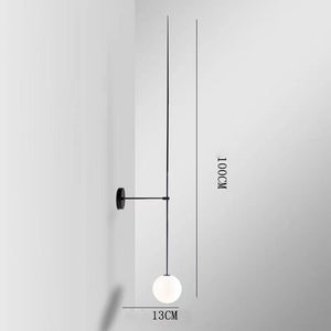 The Minimalist Line Light showcases a sleek black wall mount and round white bulb, with a 100 cm height and 13 cm horizontal rod length, embodying modern elegance and balancing form with function.