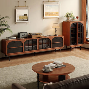 A modern living room showcases the Antique TV Cabinet Combo Set along with a glass storage cabinet, round coffee table, and decor such as books, a lamp, a plant, and framed art adorning the wall for a stylish mid-century vibe.