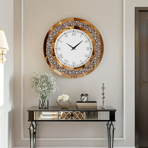 The Modern Luxury Roman Numerals Wall Clock hangs above a mirrored console table decorated with white flowers, books, and a small clock, adding elegance to the modern interior.