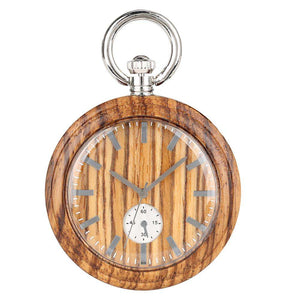 The Wood Pocket Watch features a wood grain finish, silver hour markers and hands, a metal crown, and a small seconds subdial at the bottom.