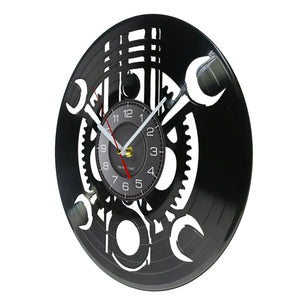 The Black Record Wall Clock features a rustic industrial design with a vinyl record aesthetic, displaying black and white colors and visible gears.
