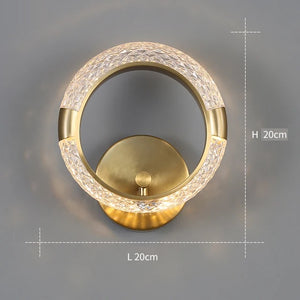 The Elegant Ring Wall Sconce, with a diameter of 20 cm and featuring a gold-colored base and a textured illuminated ring, adds an elegant touch to any space.