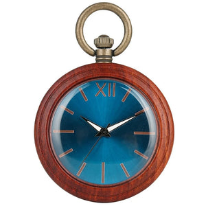 The Custom Vintage Antique Quartz Pocket Watch is a handmade wooden pocket watch with a round blue face, gold hour marks, and a metal loop. This stylish Taschenuhr displays about 7:23 and features a natural wooden outer case.