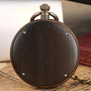 The Custom Vintage Retro Handmade Marble Dial Quartz Wood Pocket Watch Relojes De Bolsillo, featuring a dark wooden case and metal accents, rests on a vintage map beside a red book.