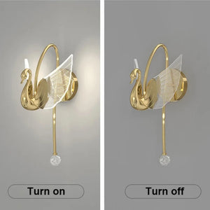Side-by-side images of the Swan Wall Light reveal its stunning design. The image on the left displays the lamp illuminated, while the one on the right shows it in its off state. This elegant indoor lighting fixture boasts a golden finish and a crystal decorative element, making it a breathtaking addition to any room's decor.