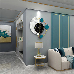 Modern living room with a gray and teal palette, highlighted by the Modernist Constellation Accent Clock in marble and gold, a round marble side table with lamp, white couch, and abstract wall art.