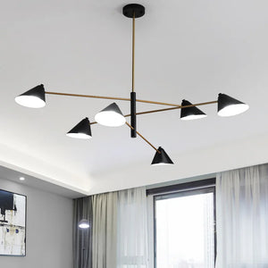 The Multi-Arm Ceiling Light is a stunning modern chandelier with six black cone-shaped lampshades on a radiant gold frame. It exemplifies elegant modern lighting with its black and gold pendant design, perfect for bright rooms featuring a window and abstract art.