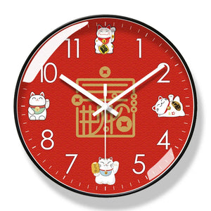 The Cartoon Cat Wall Clock is a round red clock with white hands and numerals, featuring five playful lucky cat illustrations—an ideal decorative charm for any space.