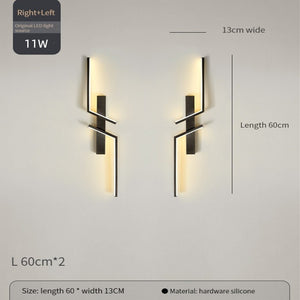 Two Minimalist Wall Sconce lights with geometric black metal designs, each measuring 60cm by 13cm, are mounted on the wall. They provide warm LED illumination for stylish and modern decorative wall lighting.