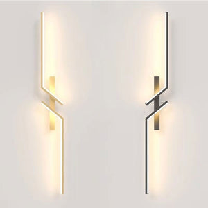 Two Minimalist Wall Sconce lights with geometric metal accents—one warm, one cool white—are mounted on a light-toned wall, providing decorative and stylish minimalist wall lighting.