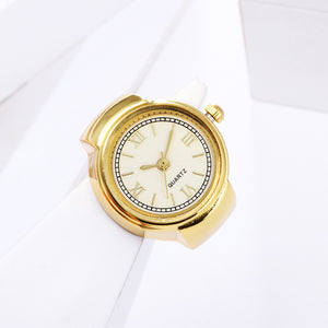 Eternal Ring Watch: A gold analog quartz wristwatch featuring a white face and Roman numerals, elegantly displayed on a white geometric surface—an ideal addition to any jewelry watches collection.