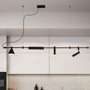 The Modern Track Lighting, a sleek black linear ceiling fixture with adjustable heads and cylindrical lights, enhances the minimalist kitchen's white cabinets and tiled backsplash, providing an industrial-inspired elegance.