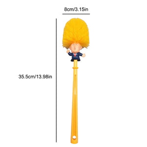 The Trump Tidy Toilet Brush features a yellow handle and bristles shaped like Trump's head in a suit, measures 35.5 cm by 8 cm, and is a perfect novelty bathroom accessory or gag gift.