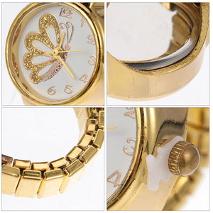 The Butterfly Ring Watch is a gold wristwatch featuring a butterfly design on the face, shown in four close-up views of its band, crown, bezel, and protective plastic near the stem—a jewelry piece reminiscent of a butterfly ring watch.