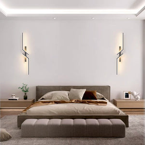 Modern bedroom with a low-profile bed, neutral bedding, nightstands, and simple decor on a wooden floor, enhanced by Minimalist Wall Sconce lighting for a stylish touch.