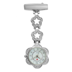 The Luxe Fob Pocket Watch features flower-shaped links, sparkling crystal accents, a white dial with Arabic numerals, and a red cross.
