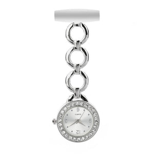 The Luxe Fob Pocket Watch features a white face, sparkling crystals set around the bezel, and comes with a silver chain link attached to a white pin.