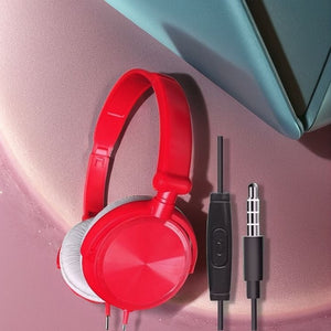 The Wired Bass Stereo Headphone in red features an adjustable over-ear design, built-in inline microphone, and 3.5mm audio jack, displayed on a pink and teal background.