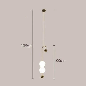 The Minimalist Line Light features three vertically arranged spherical bulbs, offering a sculptural touch. It measures 120cm in length and 60cm in width, embodying modern lighting with its sleek design.