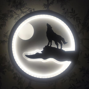 The Minimalist Wall Lamp features a design where a wolf howling on a cliff is softly illuminated by a circular LED light, creating the impression of the moon in the background—an ideal piece for infusing modern elegance into your home.