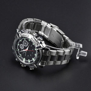 The Watch SpyCam is a stainless steel wristwatch with a black dial, luminous hour markers, and metal link band that discreetly records 1080P video & audio. Displayed on a sleek black background.