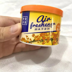 A hand holding a round container labeled "Fake Decorative Display SpyCam" with an image of flowers and text in both English and Chinese reveals a high-tech surveillance tool cleverly disguised.
