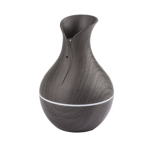 A Black Decorative Display SpyCam, designed with a dark wood grain and featuring a subtle white line near the base, seamlessly blends into modern decor.
