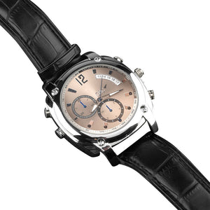 The Wristwatch SpyCam features a round metallic face, dual subdials, black leather strap, multiple adjustment buttons, and captures 1080P video with night vision—all shown on a sleek white background.