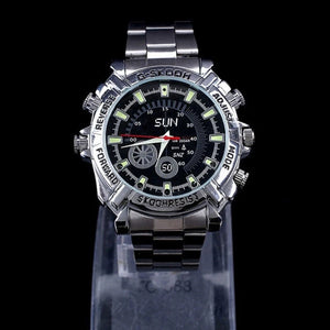 The Watch SpyCam is a silver metal wristwatch with a black dial, luminous markers, multiple buttons, and "SLIN" branding. It features a hidden 1080P camera for discreet video and audio recording and is shown on a stand against a black background.