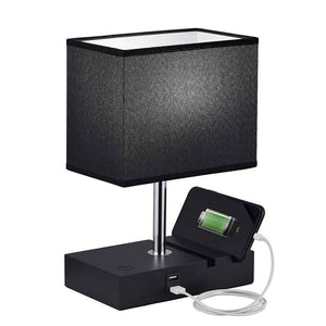 The Desk Lamp Charger SpyCam, featuring a black design with a rectangular shade and built-in HD 1080P camera, discreetly blends power and security. Its base includes a charging station, and a connected smartphone displays the charging icon.