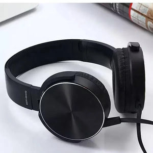 A Wired Bass Headphone with ergonomic design in black is placed on a flat white surface.