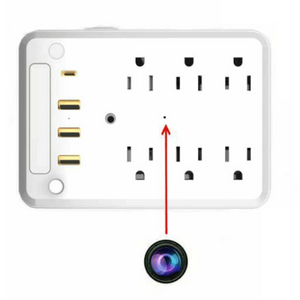 A Universal US Outlet SpyCam in white, designed as a power strip with multiple outlets and USB ports, featuring a covert surveillance camera subtly marked by a red arrow pointing to a discreet dot on its surface.