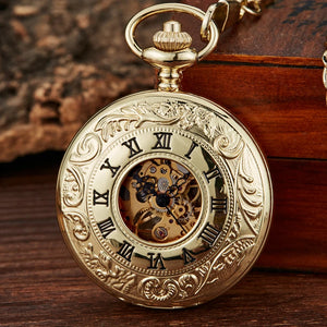 The Vintage Mechanical Pocket Watch, featuring a decorative gold case, visible inner gears, and black Roman numerals, rests on a wooden surface near a wooden box.