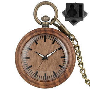 The Wooden Pocket Watch features a round wood case with black hour markers and hands, attached to a brass chain. It comes with a small black foam box with a custom cutout—an elegant choice for any wood watch collection.