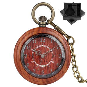 The Wooden Pocket Watch, part of the vintage collection, is round, crafted from wood, features a bronze chain, displays 8:41:00, and comes nestled in black foam with a keyhole-shaped cutout in the top right corner.