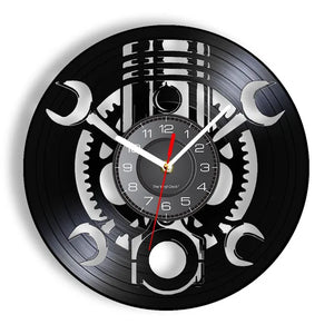 The Black Record Wall Clock is crafted from a black vinyl record featuring silver wrench cut-outs and gear patterns, and is highlighted by a striking red second hand. This rustic industrial wall clock adds unique charm to any space.