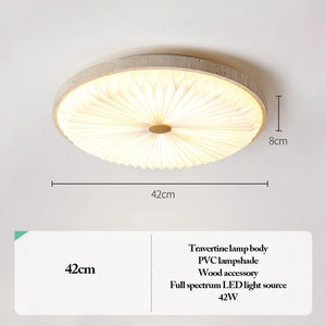 The Natural Stone Ceiling Light features a round travertine design with an 8cm thickness and 42cm diameter, complemented by an elegant pleated PVC lampshade and refined wood detailing. Equipped with a 42W full spectrum LED light source, this ceiling light beautifully merges contemporary style with the tranquil essence of wabi-sabi lighting.