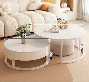 The Luxury Round Coffee Table Set features two minimalist tables: one is 70cm wide and 45cm high, the other has a marble-look top, measuring 50cm wide and 38cm high. Both are shown with decorative objects placed on top.