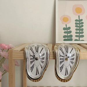 Two clocks hanging on a wooden shelf, with an artistic flair and a unique funny twist.