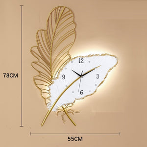 wall clock light | wall clock that lights up at night | oversized illuminated wall clock | illuminated wall clock | feather light fixture | feather art | feather art | metal feather wall decor | feather wall light | large metal feather wall art | 3 piece feather wall art | feather wall sconce