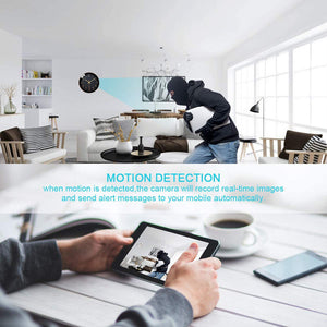 A person dressed in dark clothing and a balaclava is moving inside a modern living room, likely triggering the Motion Detection feature on the Wall Clock SpyCam. A tablet displays an HD 1080P real-time image of the intruder captured by the camera.