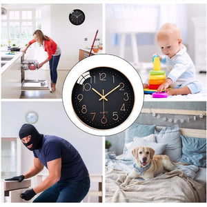 A composite image features a woman unloading a dishwasher, a baby playing with a ring stacker, a masked person using a crowbar on a cabinet, and a dog lying on a bed, all centered around the Wall Clock SpyCam.